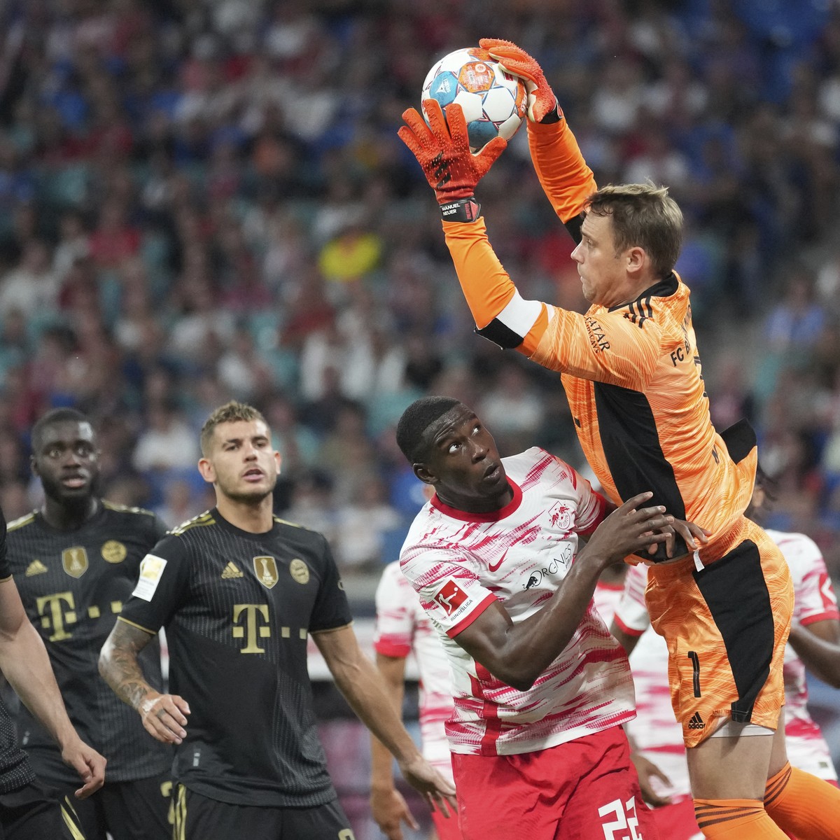 Bayern's goalkeeper Manuel Neuer, right, goes up for the save during the German Bundesliga soccer match between RB Leipzig and FC Bayern Munich in Leipzig, Germany, Saturday, Sept. 11, 2021. (AP  ...