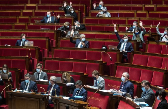 epa08997014 French members of parliament vote during a debate with Interior Minister Gerald Darmanin (C) at the National Assembly on the bill Principes Republicains&#039; (Republican Principles) in Pa ...