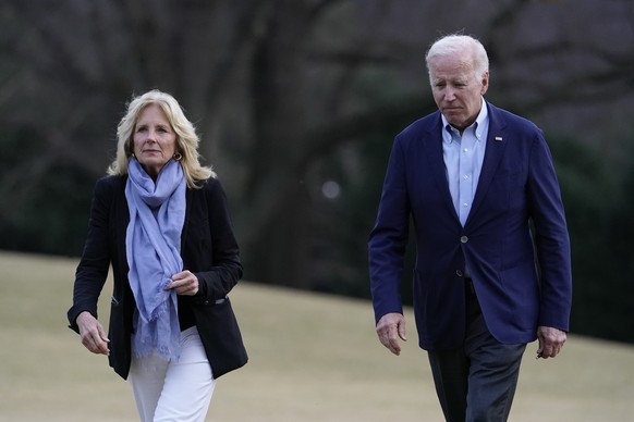 President Joe Biden and first lady Jill Biden walk on the South Lawn of the White House after stepping off Marine One, Monday, Jan. 2, 2023, in Washington. The Bidens are returning to Washington after ...