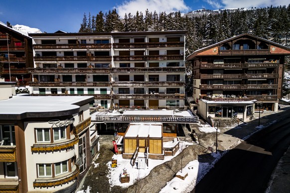 Snow covers the entrance to the "Le Constellation" bar, three months after the tragedy, in Crans-Montana, Switzerland, Wednesday, April 1, 2026. (KEYSTONE/Jean-Christophe Bott)