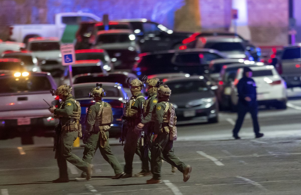 Law enforcement agents walk in the parking lot of a shopping mall, Wednesday, Feb. 15, 2023, in El Paso, Texas. Police say one person was killed and three other people were wounded in a shooting at Ci ...