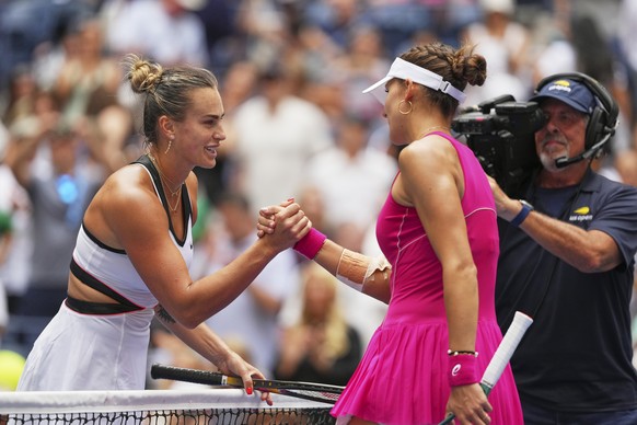 Aryna Sabalenka, of Belarus, shakes hands with Rebeka Masarova, of Switzerland, after winning their first-round match of the US Open tennis championships, Sunday, Aug. 24, 2025, in New York. (AP Photo ...
