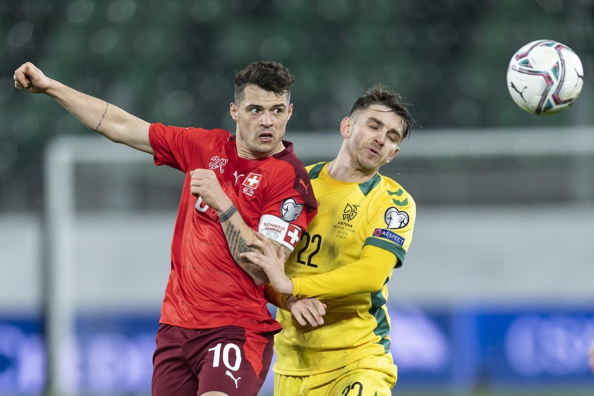 Switzerland's Granit Xhaka, left, fights for a header against Lithuania's Fedor Cernych during the FIFA World Cup Qatar 2022 qualifying Group C soccer match between Switzerland and Lithuania ...
