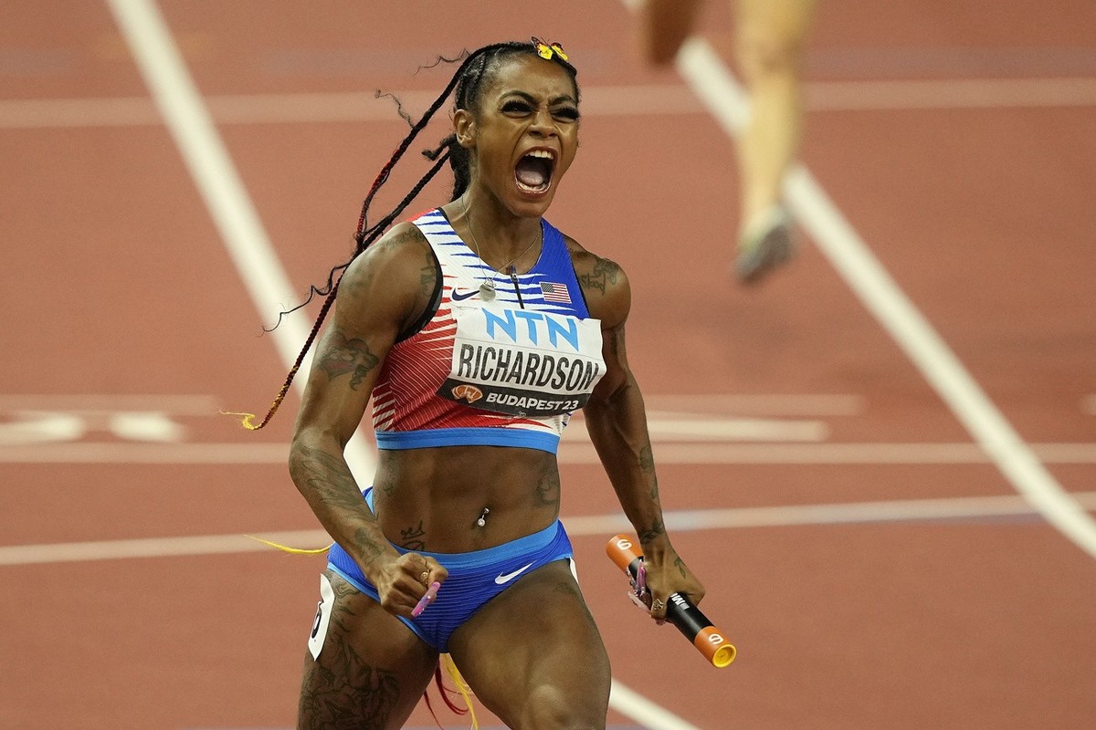Sha'Carri Richardson, of the United States, celebrates after she crosse the finish line to anchor her team to gold in the Women's 4x100-meters relay final during the World Athletics Champion ...