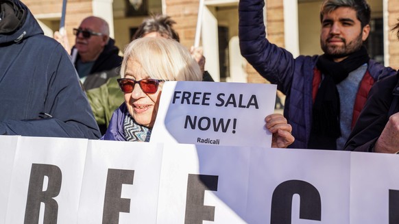 epa11797204 People hold placards while attending a peaceful sit-in in front of the Prefecture to demand the immediate release of the Italian journalist Cecilia Sala in Turin, Italy, 29 December 2024.  ...