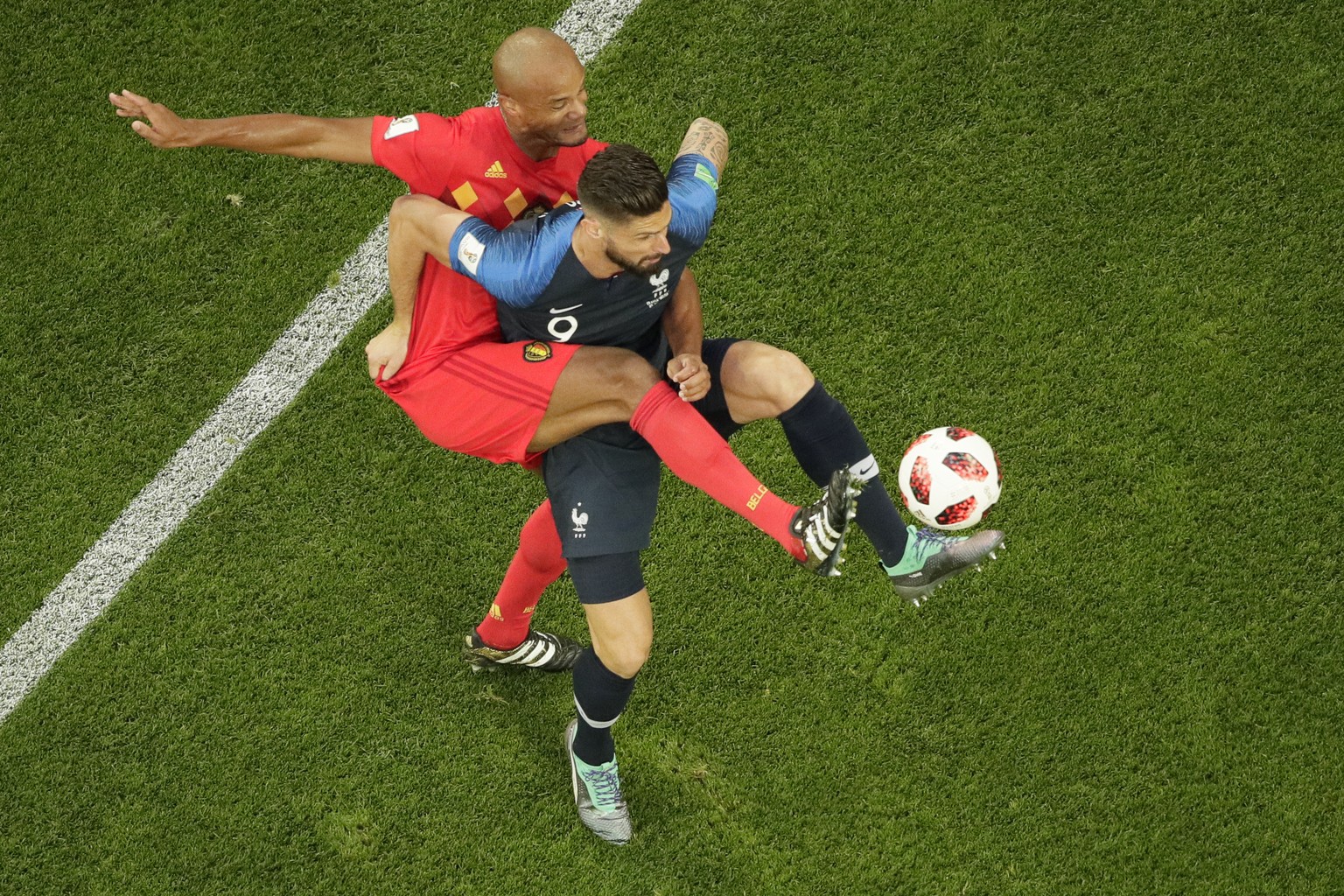 France&#039;s Olivier Giroud, right, is challenged by Brazil&#039;s Pedro Geromel during the semifinal match between France and Belgium at the 2018 soccer World Cup in the St. Petersburg Stadium in St ...