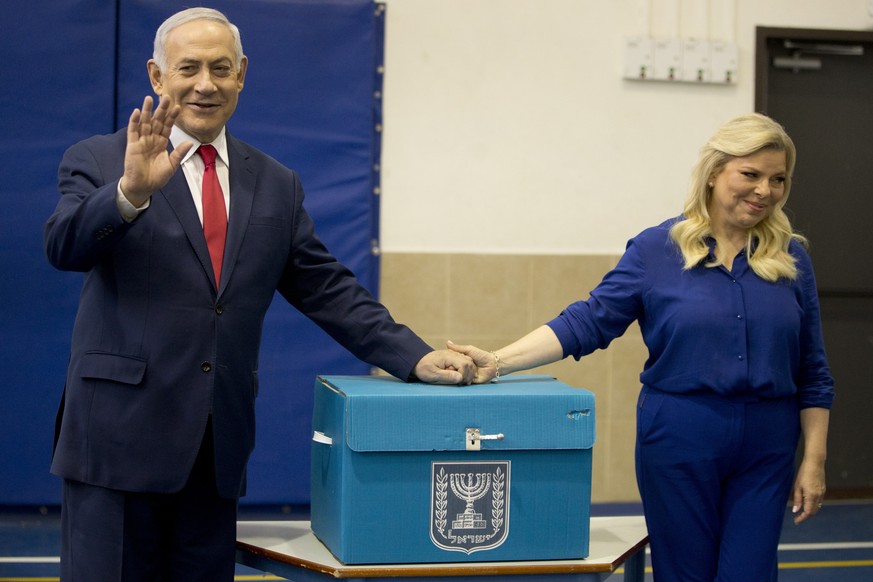 epa07493943 Israeli Prime Minister Benjamin Netanyahu (L) waves with his wife Sara after voting during Israel&#039;s parliamentary elections in Jerusalem, 09 April 2019. Polls opened nation-wide as Is ...
