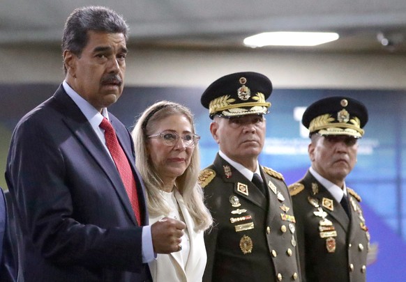 epa12622477 (FILE) - (L-R) Venezuelan President Nicolas Maduro, accompanied by his wife, Celia Flores, and Venezuelan Minister of Defence Vladimir Padrino Lopez, arrives to the Supreme Court of Justic ...