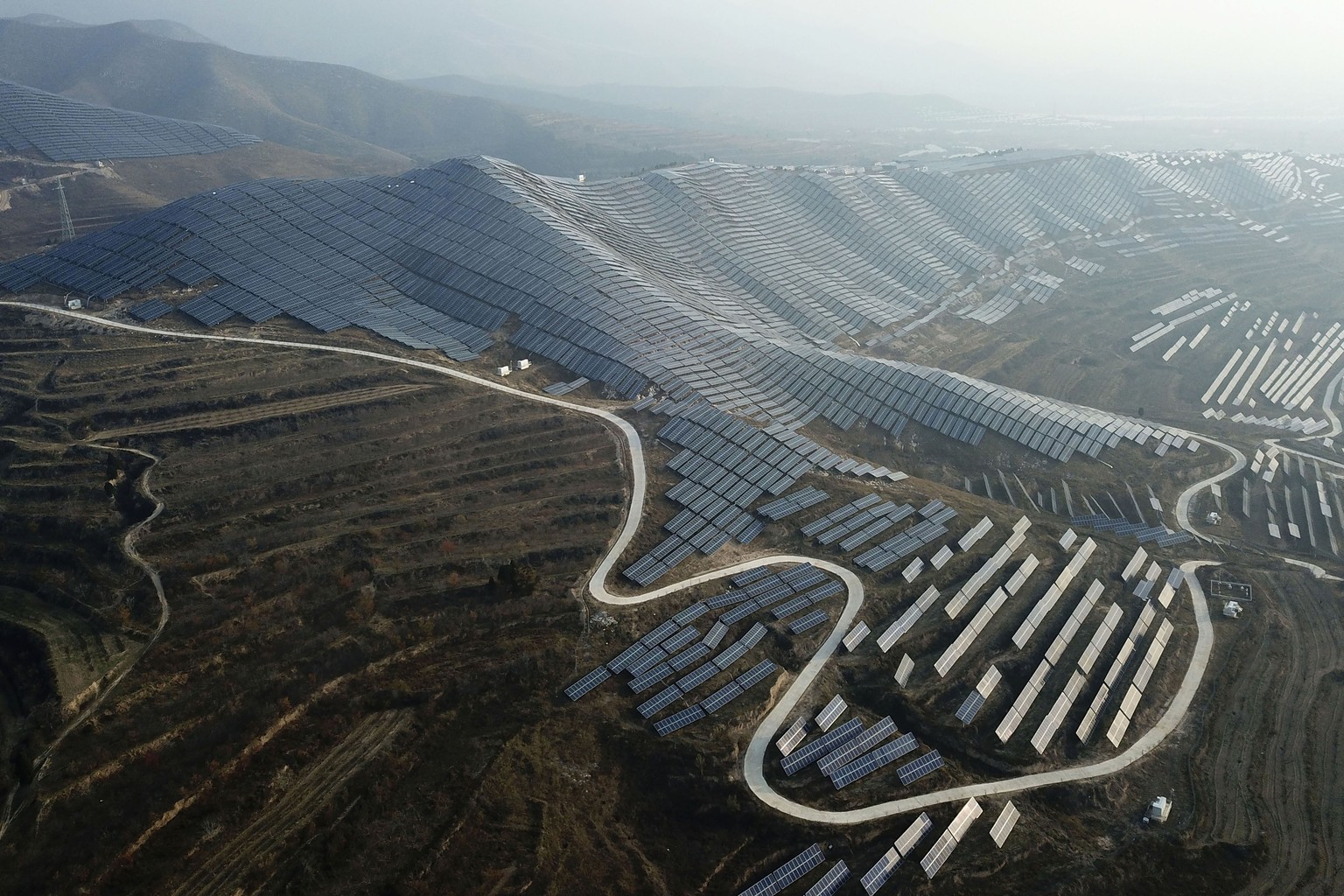 FILE - This photo shows a solar panel installation in Ruicheng County in central China's Shanxi province on November 28, 2019. China has imposed export restrictions on two metals used in computer chips and...