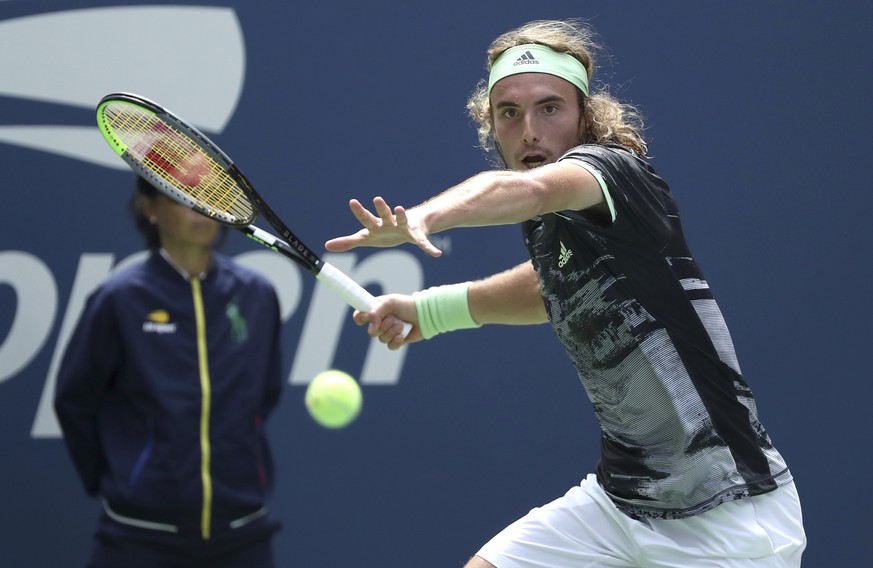 Stefanos Tsitsipas, of Greece, returns a shot to Andrey Rublev, of Russia, during the first round of the US Open tennis tournament Tuesday, Aug. 27, 2019, in New York. (AP Photo/Kevin Hagen)