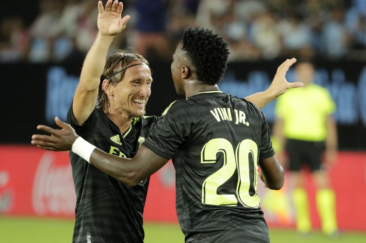 Real Madrid's Vinicius Junior, right, celebrates with Real Madrid's Luka Modric after scoring his side's third goal during a Spanish La Liga soccer match between Celta Vigo and Real Mad ...