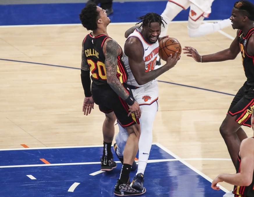 New York Knicks forward Julius Randle (30) drives against Atlanta Hawks forward John Collins (20) during the third quarter of an NBA basketball game Wednesday, April 21, 2021, in New York. (Wendell Cr ...