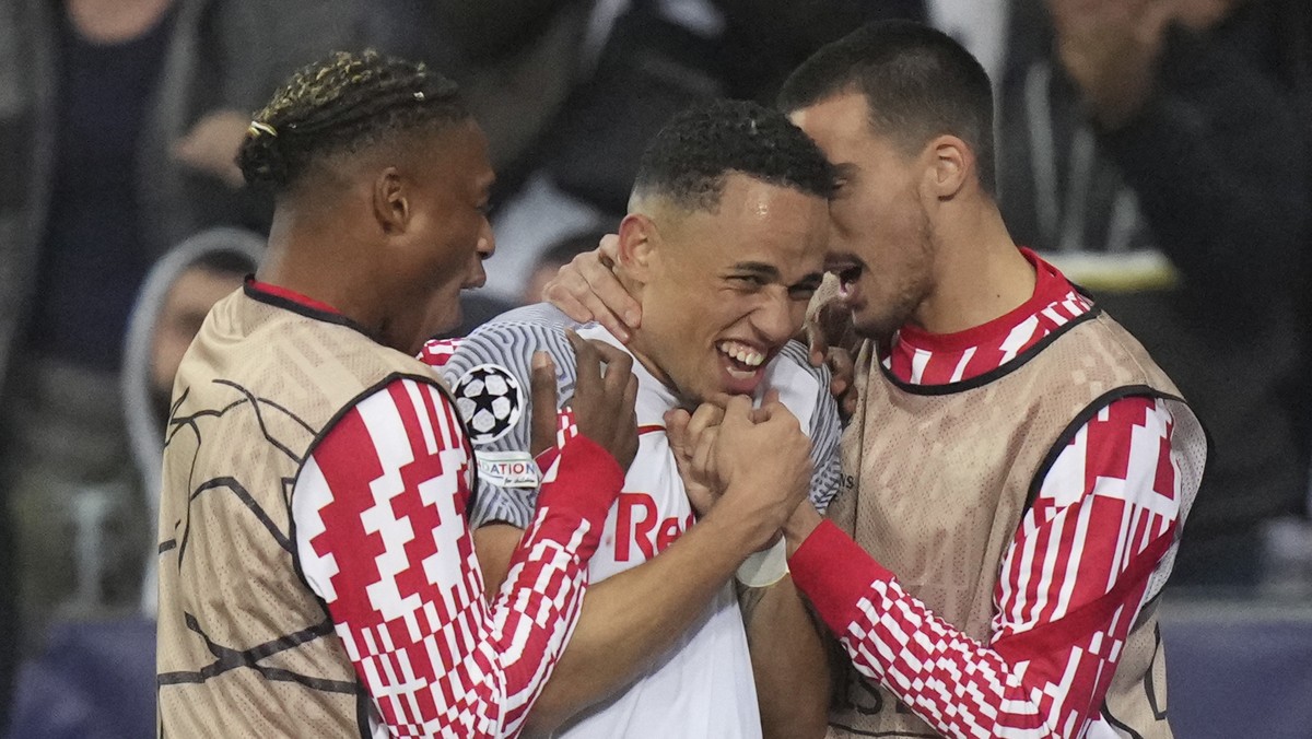 Salzburg's Noah Okafor, center, celebrates after scoring his side's third goal during the Champions League group G soccer match between Salzburg and VfL Wolfsburg, at the Salzburg stadium, i ...