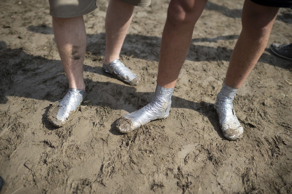 Visitors present their in gaffer tape wraped feet, pictured during the music festival Openair St. Gallen, on Saturday, June 27, 2015, in St. Gallen, Switzerland. The event runs until June 28. (KEYSTON ...