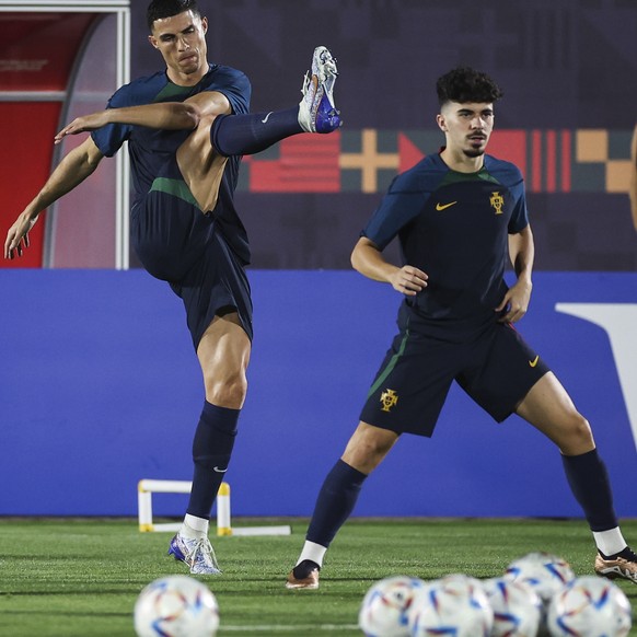 epa10349748 Portugal players Cristiano Ronaldo (C) and Vitinha (R) attend a training session in Al-Shahaniya, Qatar, 05 December 2022. Portugal will face Switzerland in their round of 16 match at the  ...
