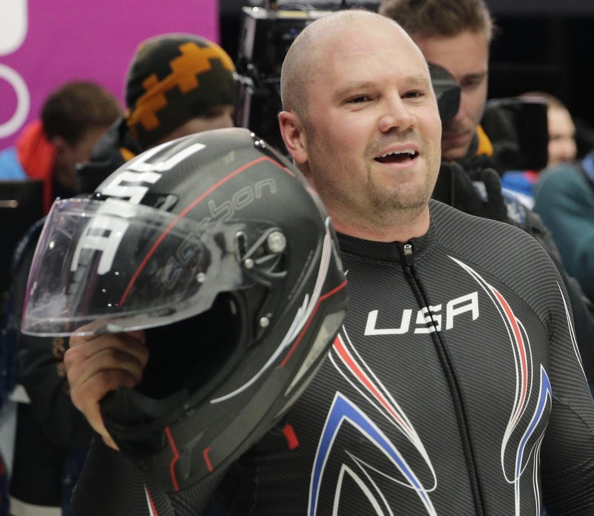 The pilot from the United States USA-1, Steven Holcomb celebrates his bronze medal win in the men's two-man bobsled competition at the 2014 Winter Olympics, Monday, Feb. 17, 2014, in Krasnaya Pol ...