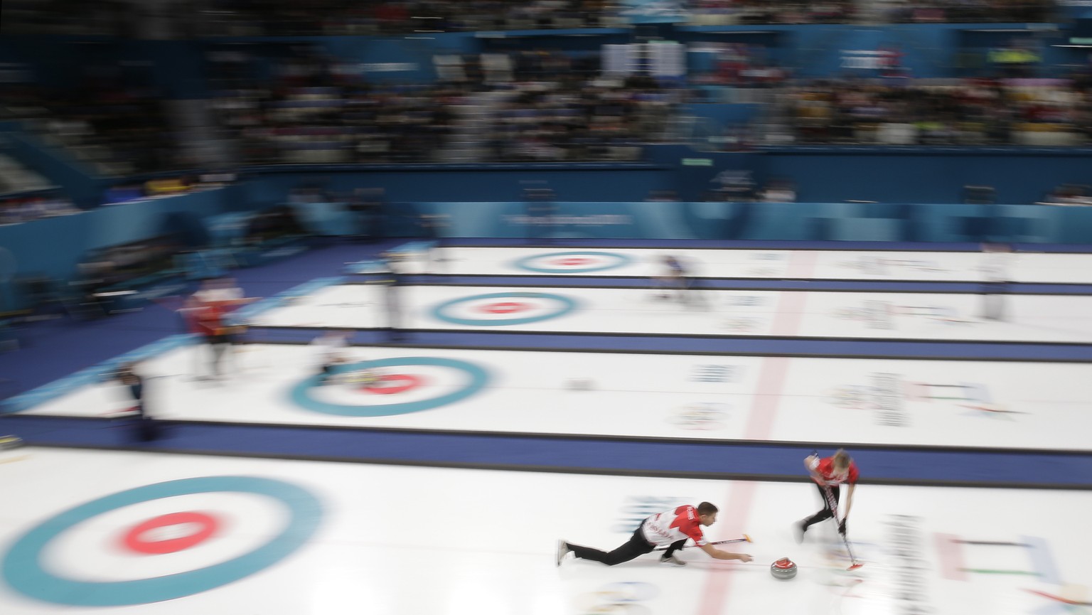 Canada&#039;s Kaitlyn Lawes and John Morris prepare to throw the stone during their mixed doubles curling match against South Korea at the 2018 Winter Olympics in Gangneung, South Korea, Sunday, Feb.  ...