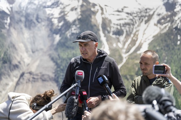 Members of the government of the canton of Valais, Christophe Darbellay, left, and the president of the government Mathias Reynard, speak to the media in front of the massive avalanche, triggered by t ...