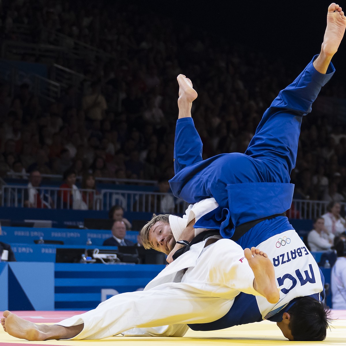Switzerland's Nils Stump, left, fights against Mongolia's Erdenebayar Batzaya during the Judo Men 73 kg Elimination Round of 32 at the 2024 Paris Summer Olympics in Paris, France, Monday, Ju ...