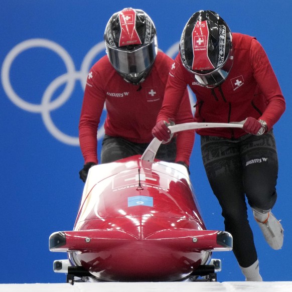 Melanie Hasler of Switzerland starts a run during a 2-woman bobsled training at the 2022 Winter Olympics, Wednesday, Feb. 16, 2022, in the Yanqing district of Beijing. (AP Photo/Mark Schiefelbein)