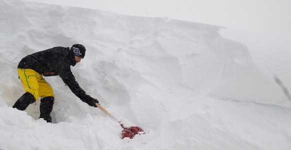 epa07269603 A man tries to remove snow from a roof of a house in Filzmoos, Austria, 08 January 2019. Media reports state that many regions in Austria, Germany, Switzerland and northern Italy have been ...