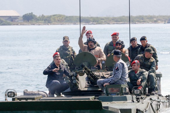 epa07326223 A handout photo made available by the Miraflores Press, shows Venezuelan President Nicolas Maduro (C) as he leads a military exercise, in Caracas, Venezuela, 27 January 2019. Maduro led on ...