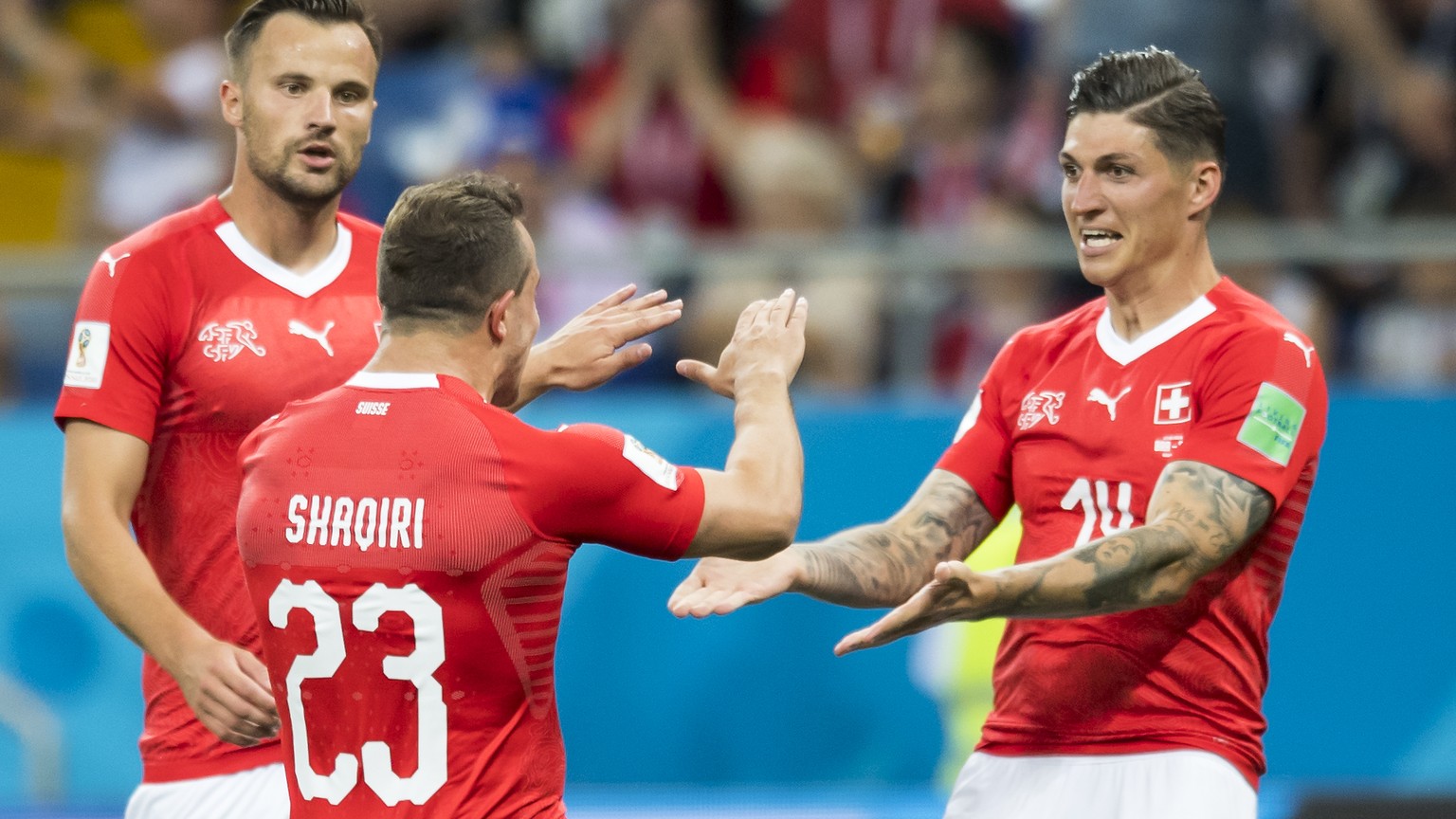 Switzerland&#039;s midfielder Steven Zuber, right, celebrates after scoring a goal with Switzerland&#039;s forward Haris Seferovic, and Switzerland&#039;s midfielder Xherdan Shaqiri, during the FIFA s ...