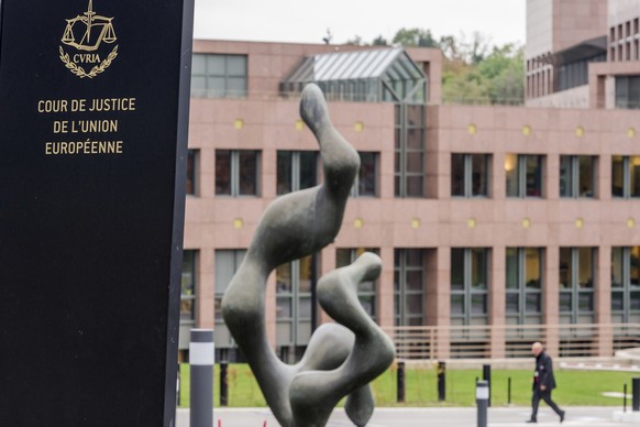 FILE - A man walks by the European Court of Justice in Luxembourg, Oct. 5, 2015. A top European Union court rejected on Wednesday, Nov. 9, 2021. The European Union���s top court ruled Thursday, June 9 ...