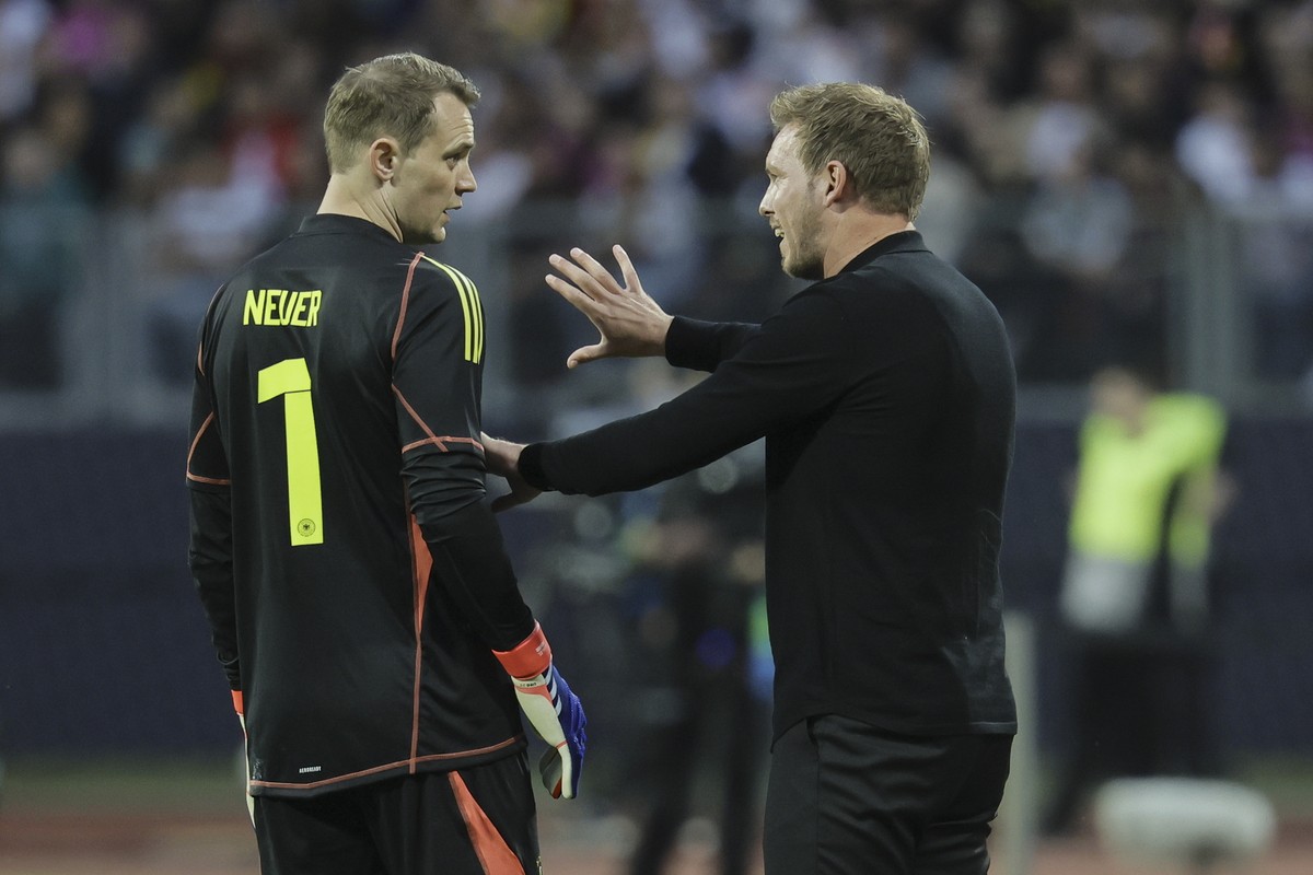 epa11388115 Head coach Julian Nagelsmann of Germany (R) talks to goalkeeper Manuel Neuer of Germany (L) during the international friendly soccer match between Germany and Ukraine in Nuremberg, Germany ...