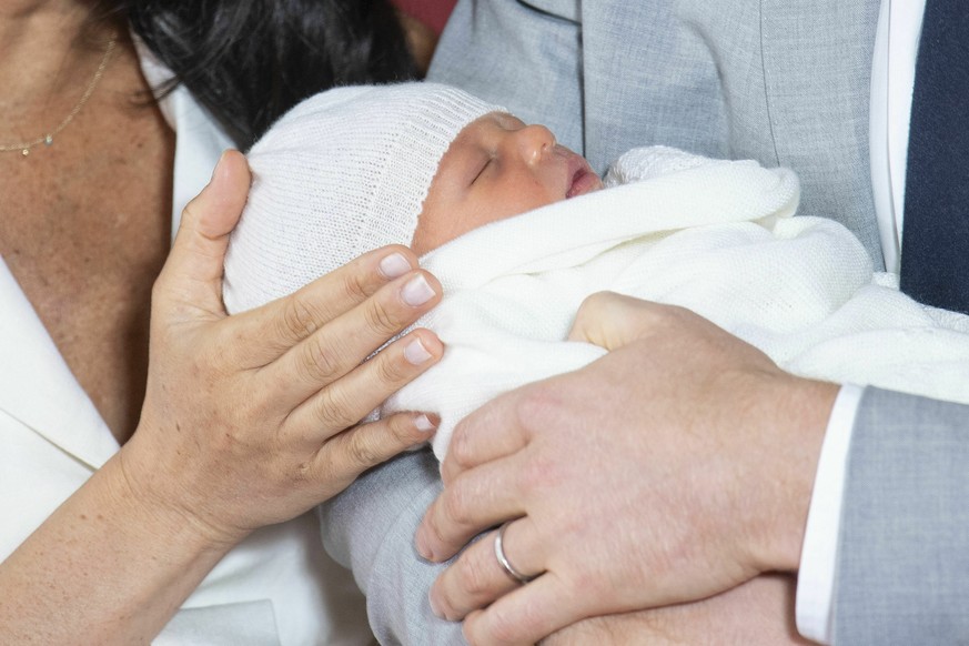 Britain&#039;s Prince Harry and Meghan, Duchess of Sussex, during a photocall with their newborn son, in St George&#039;s Hall at Windsor Castle, Windsor, south England, Wednesday May 8, 2019. Baby Su ...