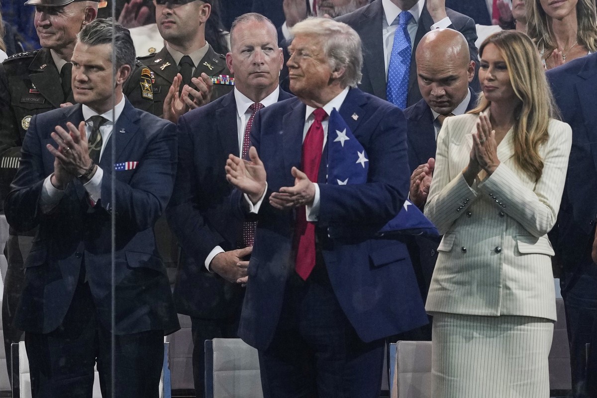 President Donald Trump, first lady Melania Trump, and Defense Secretary Pete Hegseth applaud during attend a military parade commemorating the Army's 250th anniversary, coinciding with his 79th b ...