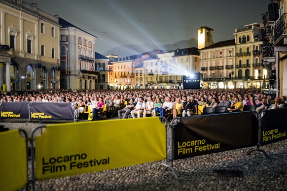epa12292147 Festival-goers watch a movie on the Piazza Grande square during the 78th Locarno International Film Festival, in Locarno, Switzerland, 09 August 2025 (issued 10 August 2025). The festival  ...