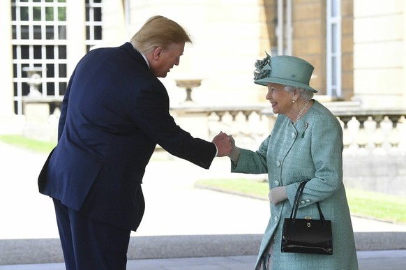 Britain&#039;s Queen Elizabeth II greets President Donald Trump as he arrives for a welcome ceremony in the garden of Buckingham Palace, in London, Monday, June 3, 2019, on the first day of a three da ...