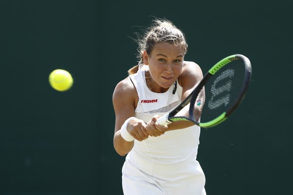 Ylena In-Albon of Switzerland in action during her girls&#039; singles match against Violet Apisah of Papua New Guinea, at the Wimbledon Championships at the All England Lawn Tennis Club, in London, B ...