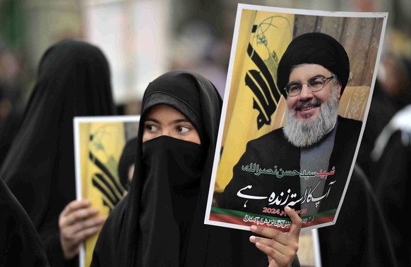 epa11632819 Supporters of Shi&#039;ite Muslims organization Majlis-e-Wahdat-e-Muslameen (MWM), hold pictures of late Hezbollah leader Hassan Nasrallah during an anti-Israel protest in Lahore, Pakistan ...