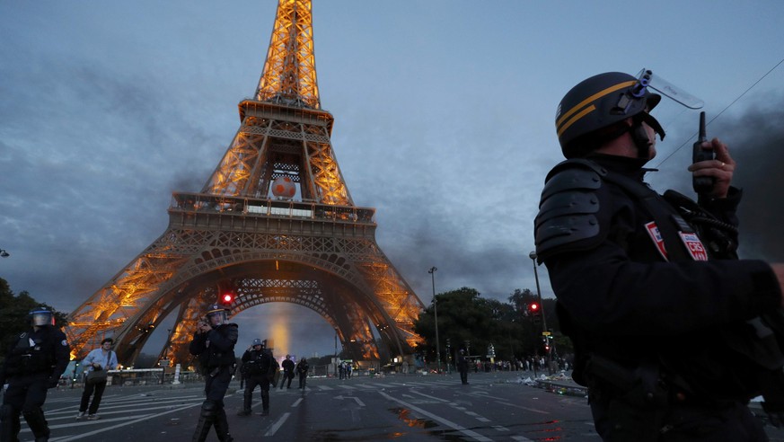 French CRS riot police hold a position during clashes near the Eiffel Tower at the Paris fan zone during the Portugal v France EURO 2016 final soccer match in Paris, France, July 10, 2016. French poli ...