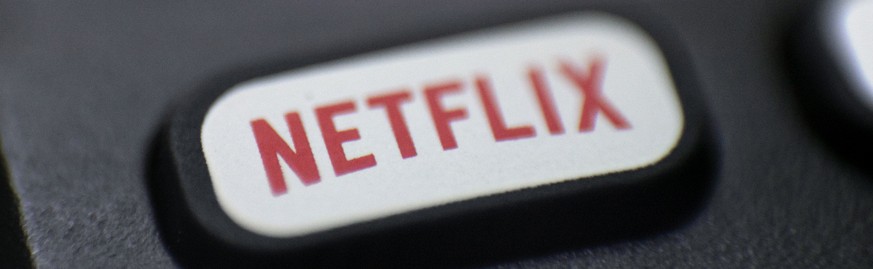 FILE - This Aug. 13, 2020 file photo shows a logo for Netflix on a remote control in Portland, Ore. Netflix is raising most of its U.S. prices by 8% to 13% as its video streaming service rides a wave  ...