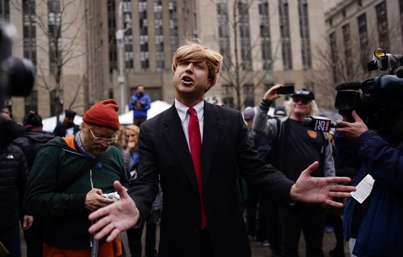 epa10558202 A Trump impersonator outside New York Criminal Court in New York, New York, U.S., April 4, 2023. A Manhattan grand jury voted last week to indict former President Donald J. Trump and he will...