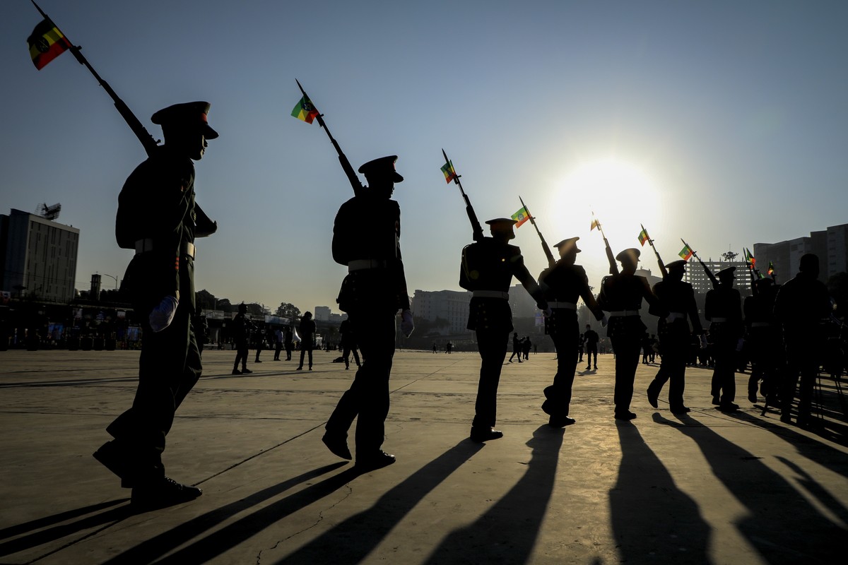 FILE - Ethiopian military parade with national flags attached to their rifles at a rally organized by local authorities to show support for the Ethiopian National Defense Force (ENDF), at Meskel squar ...