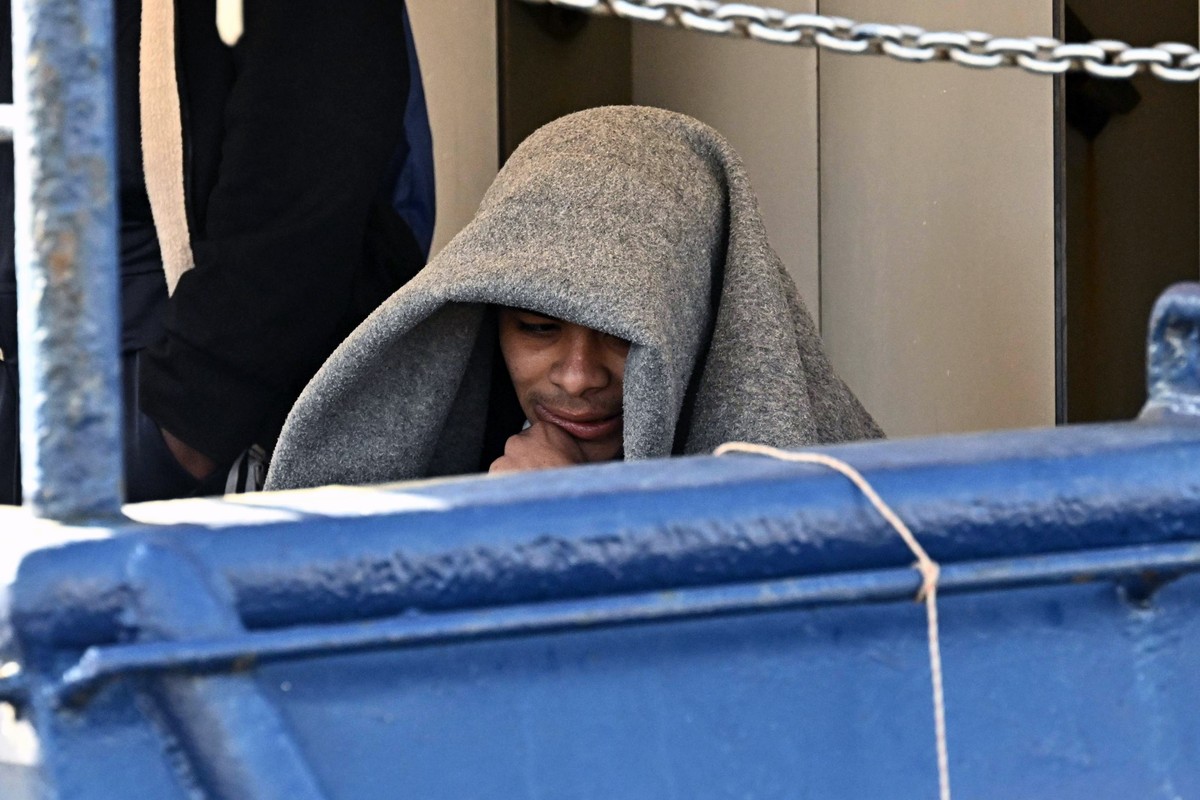 epa12017233 A migrant sits covered with a blanket on the NGO ship 'Humanity 1' as it arrives in the port of Genoa, Italy, 08 April 2025. The vessel carried a total of 88 migrants. EPA/LUCA Z ...