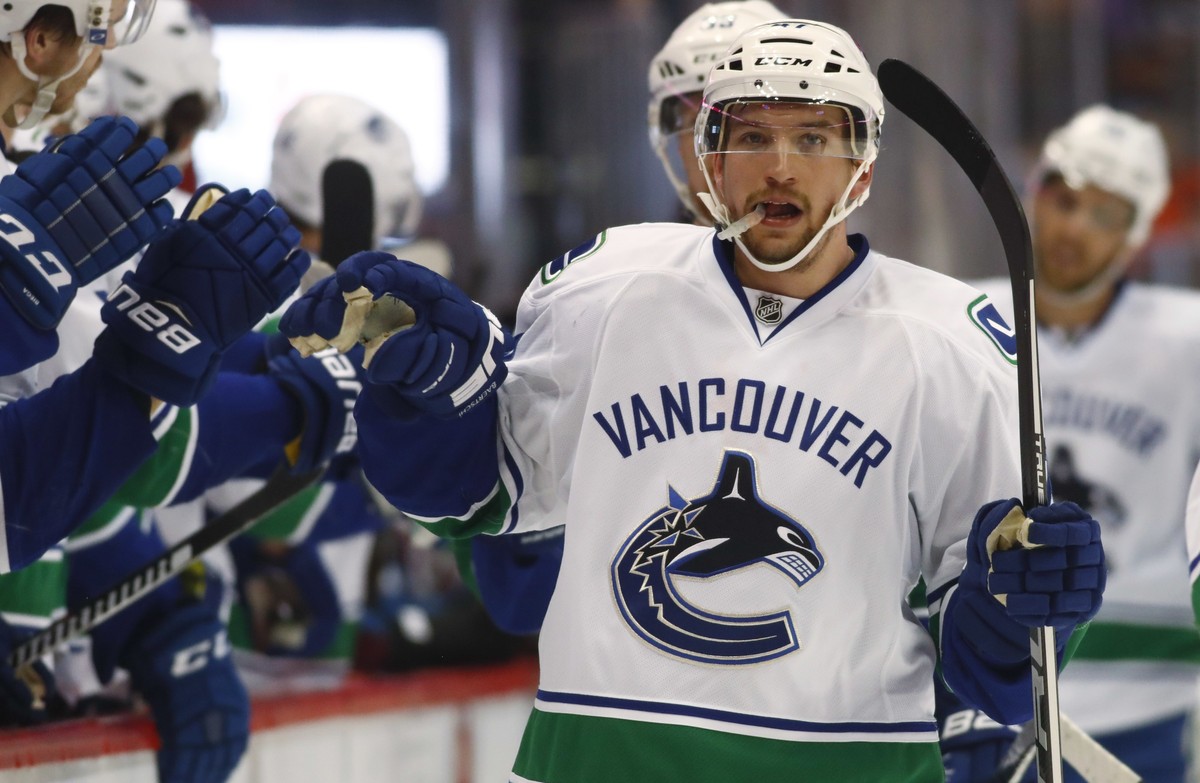 Vancouver Canucks left wing Sven Baertschi, of the Czech Republic, is congratulated as he passes the team box after scoring the go-ahead goal against the Colorado Avalanche during the third period of  ...