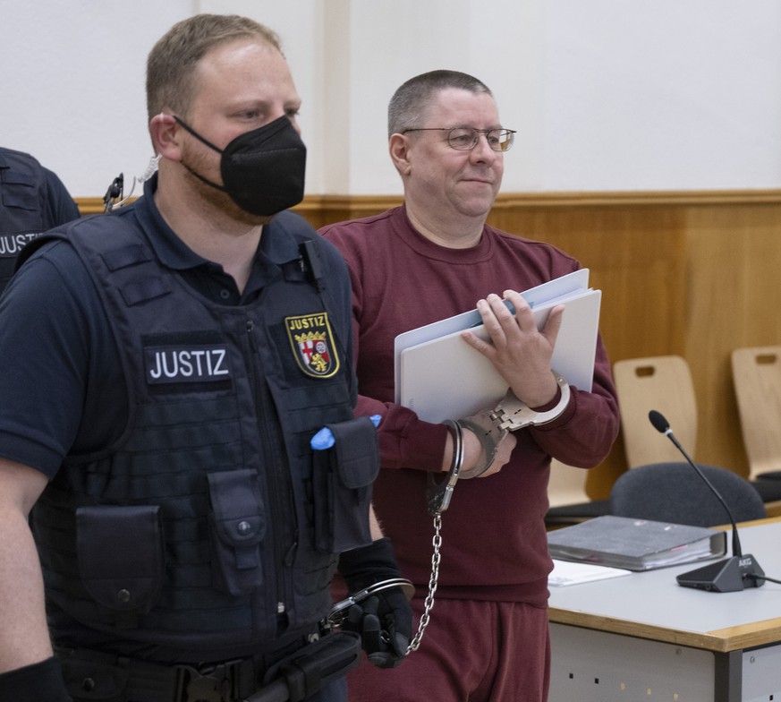 At the start of the trial, the defendant Sven Birkmann, right, is led into the courtroom in Koblenz, Germany, Wednesday, May 17, 2023. Five people are going on trial in Germany accused of planning a c ...