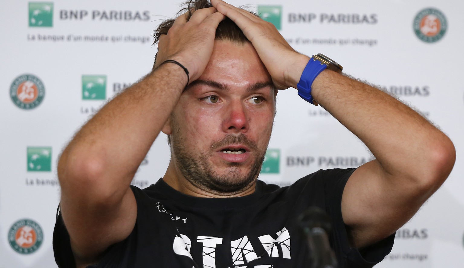 Switzerland&#039;s Stan Wawrinka pulls back his hair during a press conference after losing to Spain&#039;s Guillermo Garcia-Lopez in their first round match of the French Open tennis tournament at th ...