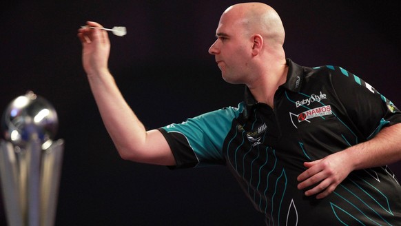 epa06413075 Rob Cross of England in action against Phil Taylor of England (not seen) during their PDC World darts final match at the Alexander Palace in North London, Britain, 01 January 2018. EPA/SEA ...