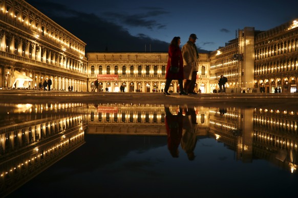 Local and tourists walk along a nearly empty St. Mark&#039;s square in Venice, Italy, Tuesday, March 3, 2020. G-7 countries say they are ready to take action to cushion the economic impacts of the new ...