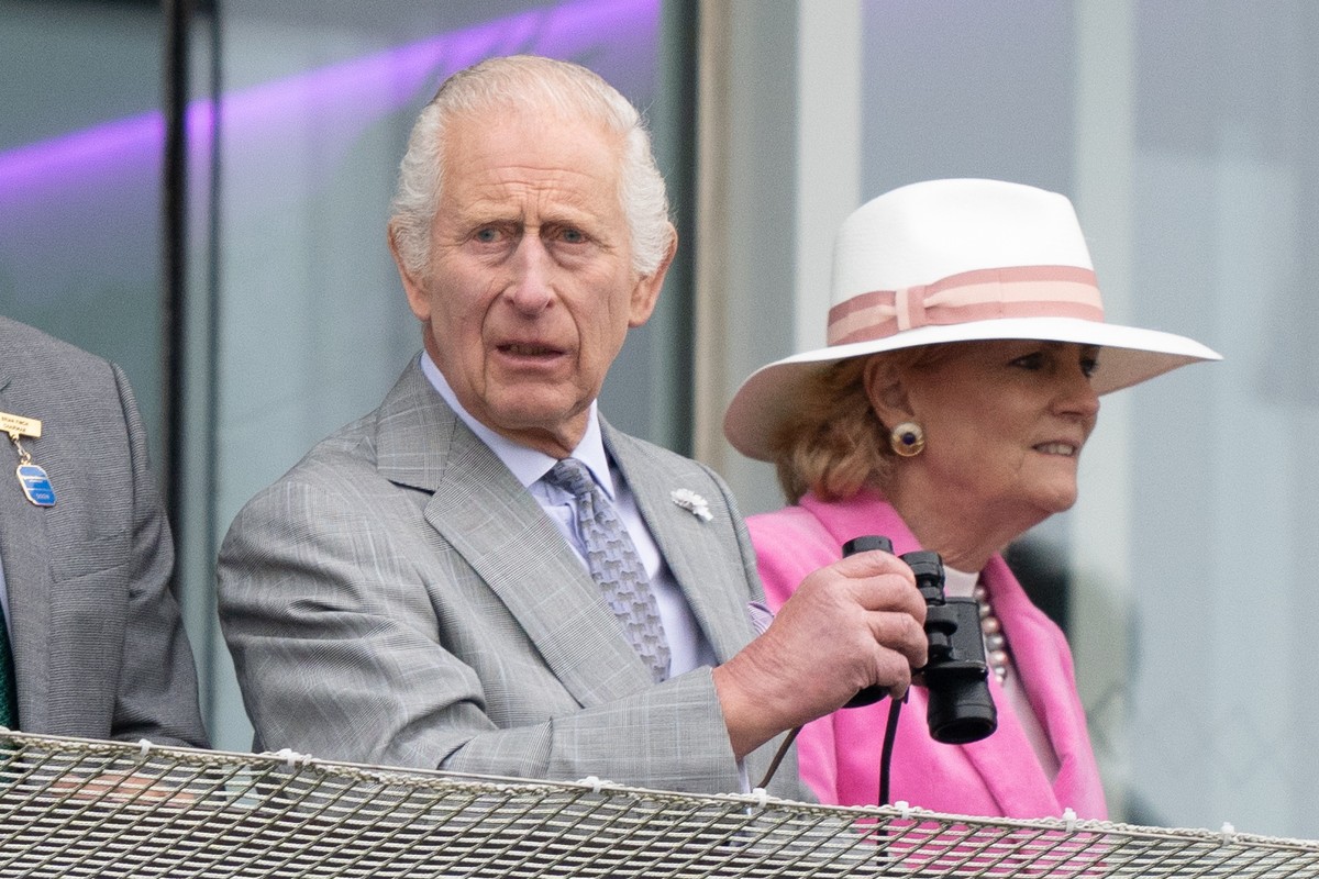 epa11382209 Britain's King Charles III watches his horse Treasure racing during Ladies Day at the Epsom Derby in Epsom Downs in Surrey, Britain, 31 May 2024. The Epsom Derby Festival of horse rac ...