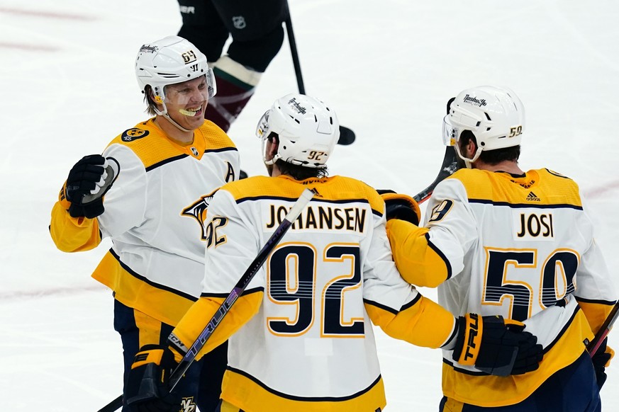 Nashville Predators defenseman Roman Josi (59) celebrates his goal against the Arizona Coyotes with centers Ryan Johansen (92) and Mikael Granlund (64) during the third period of an NHL hockey game Sa ...