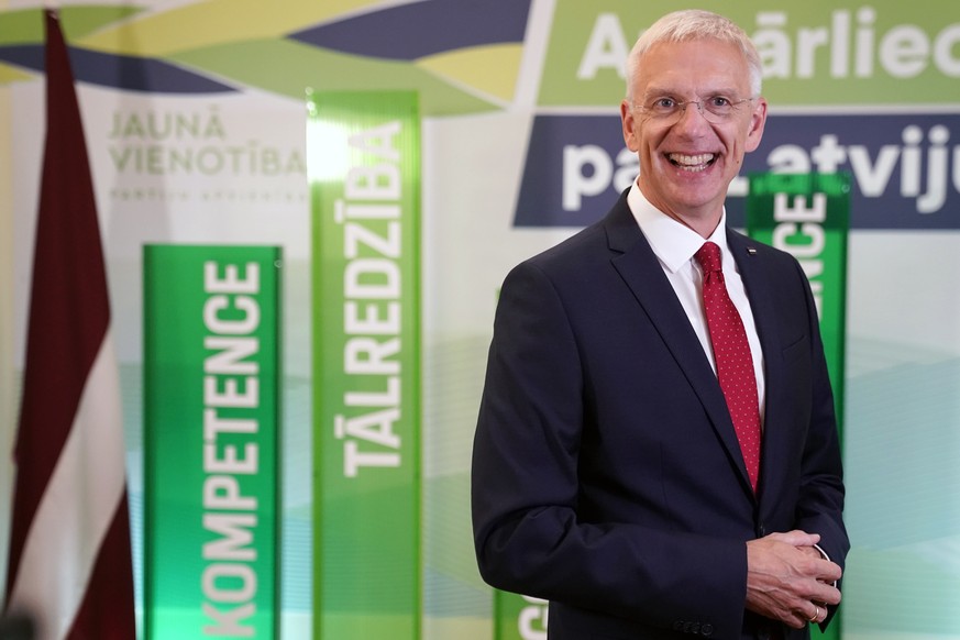 Latvian Prime Minister and Head of board of leading political party Jauna Vienotiba (New Unity) Krisjanis Karins smiles as he speaks to the media while awaiting the results of parliament elections, in ...