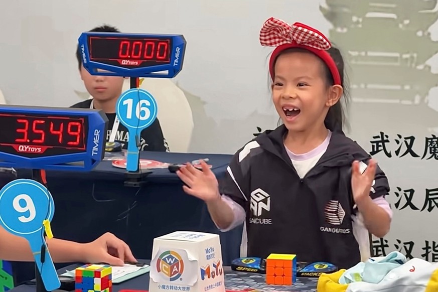 In this photo taken from video and released by YouTube@cuberootme, 6-year-old Lian Yunzhi reacts after solving a Rubik's cube at a World Cube Association-certified competition in the central Chin ...