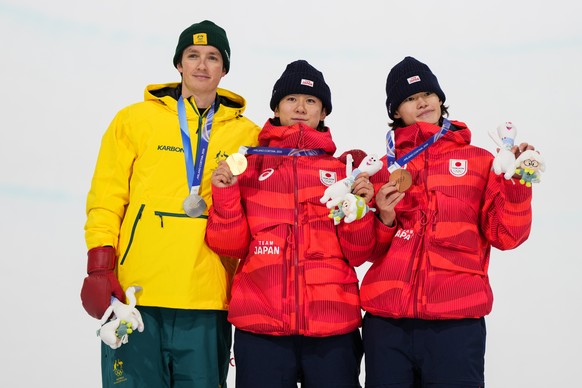 From left, silver medalist Australia's Scotty James, gold medalist Japan's Yuto Totsuka and bronze medalist Japan's Ryusei Yamada stand on the podium after the men's snowboarding h ...